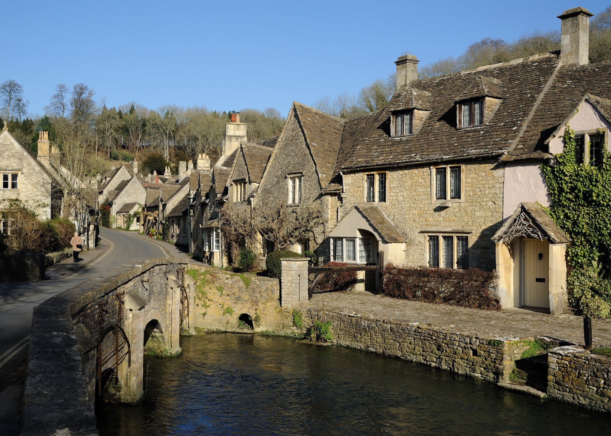 Castle Combe is a small Cotswold village in Wiltshire, England. It is renowned for its attractiveness and for fine buildings including the medieval church. More recently it was the setting for the movie War Horse .